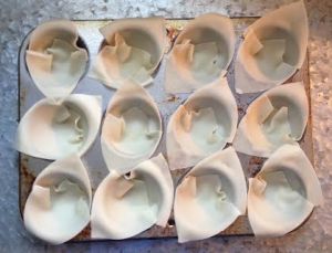 Overlap 2 wonton wrappers (so the bottom & edges are covered to form the "shell") & press the bottom into the cups. 